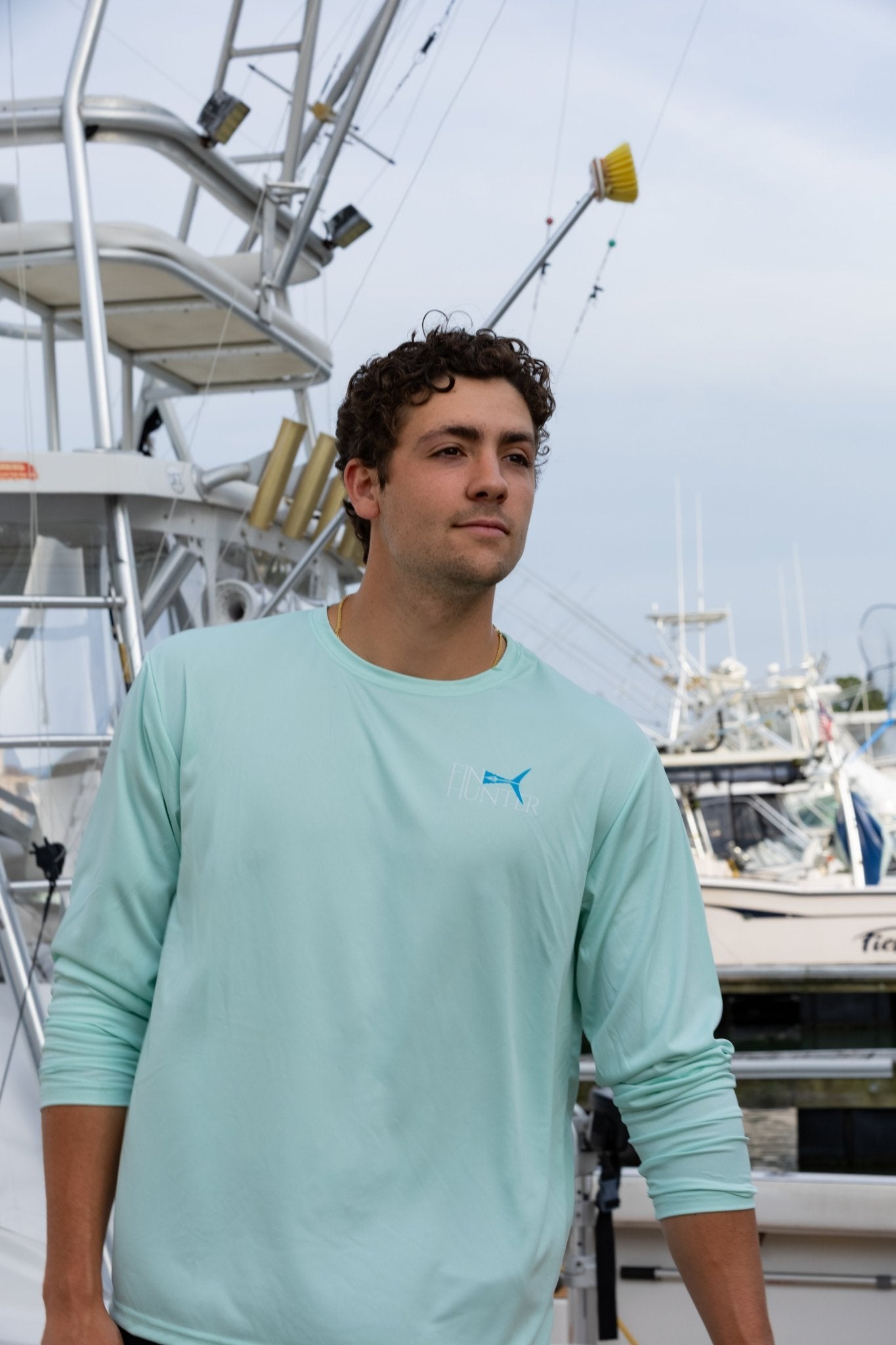 Man wearing the Fin Hunter Tail Blue Camo Sun Shirt in Pastel Mint, front view